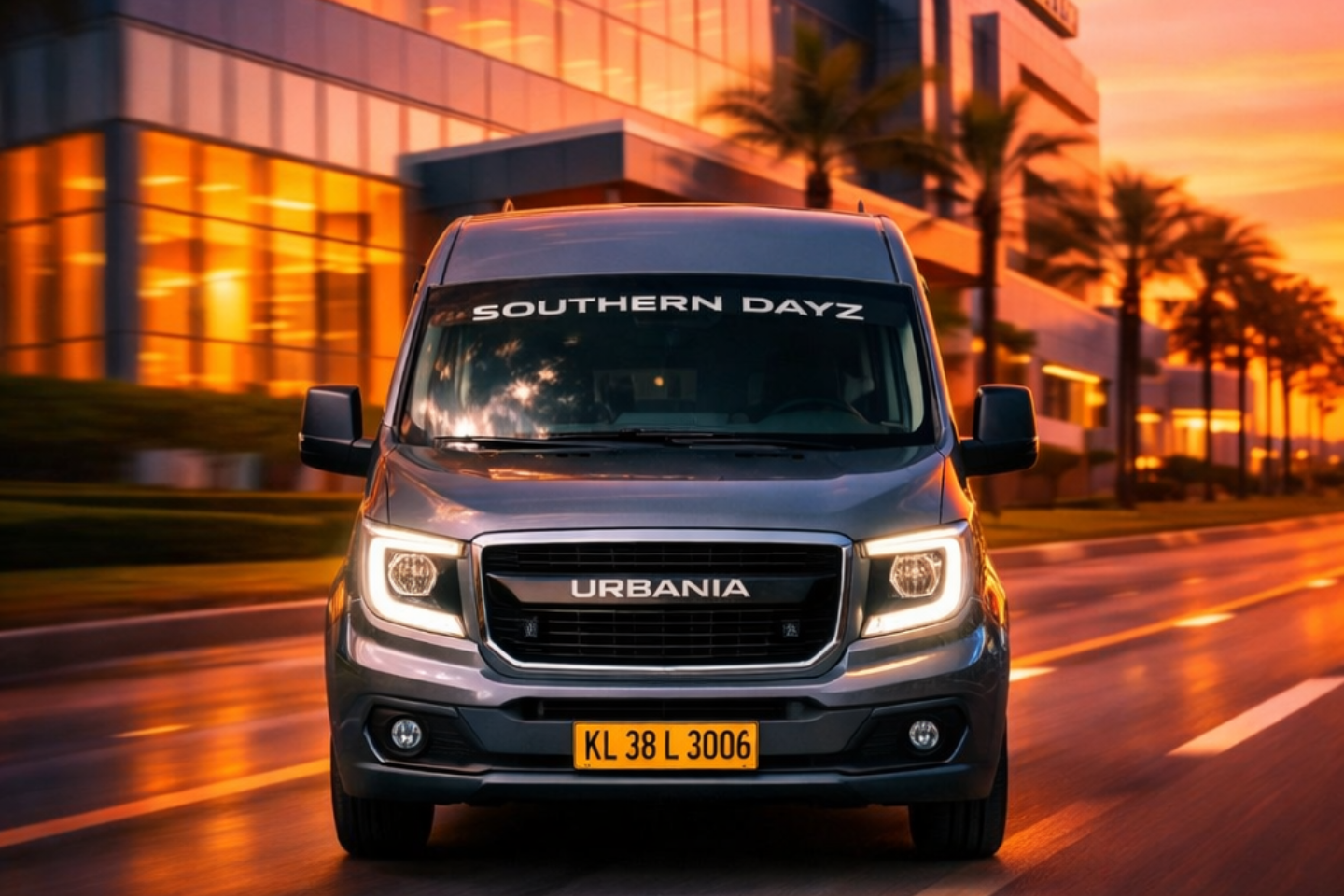 Premium Force Urbania van by Southern Dayz driving on a city road at sunset, front view with LED headlights, palm-lined modern buildings in the background, Kerala registration plate visible.